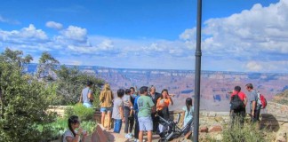 Tourists enjoy the amazing view behind the Bright Angel Lodge at the Grand Canyon National Park