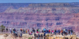 Tourists who've taken the Grand Canyon Airplane tour to the South Rim enjoy the views at Mather Point.